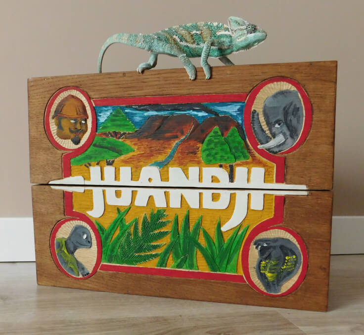 Wooden case of "Juandji" board game, with live chameleon sitting on top